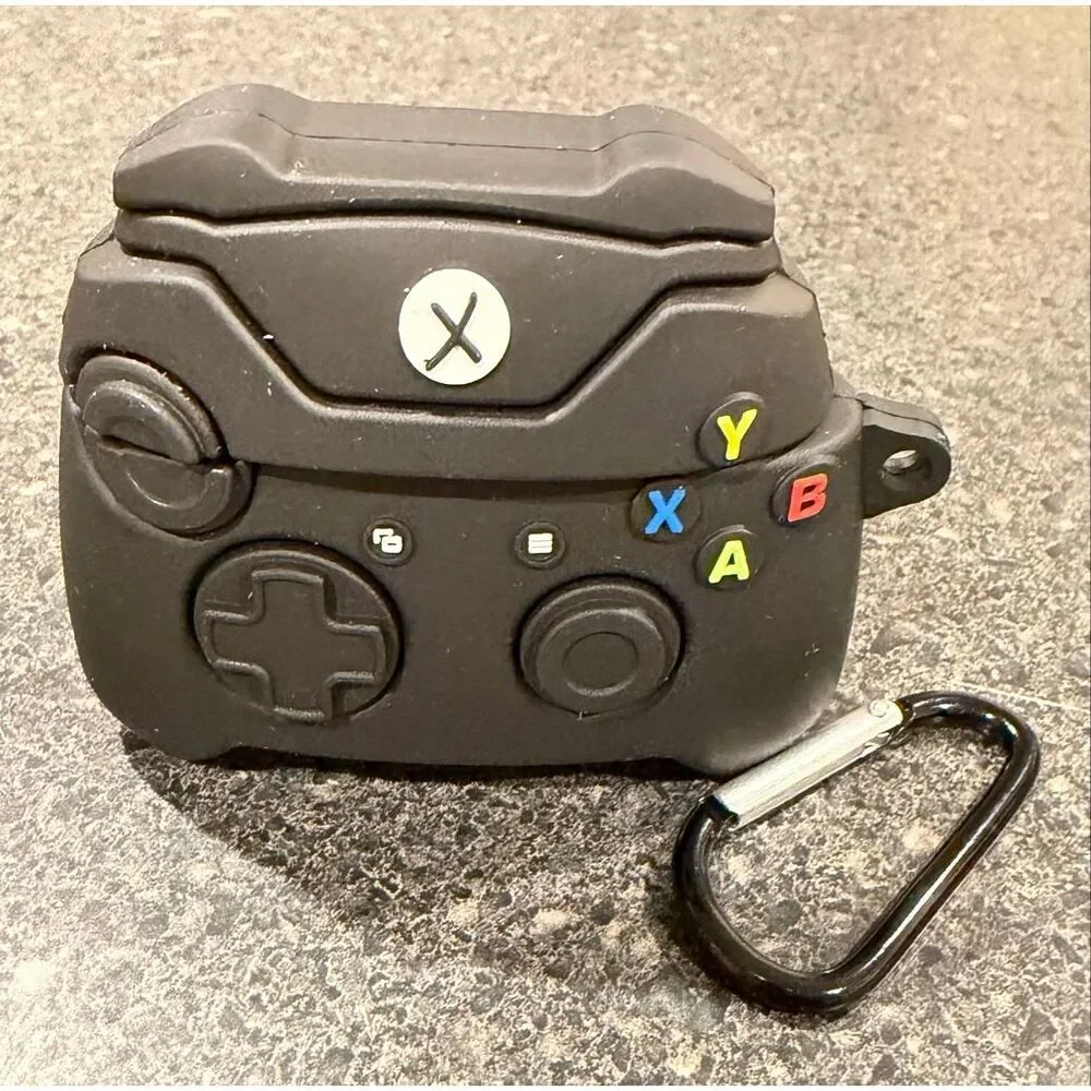 Silicone protective case for Apple AirPods, designed to resemble a black Xbox co